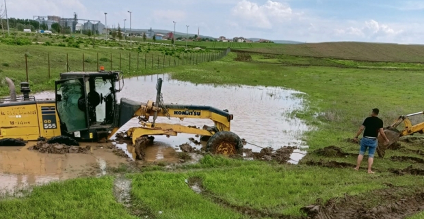 Alaca'da sele müdahale eden iş makinesi toprağa saplandı